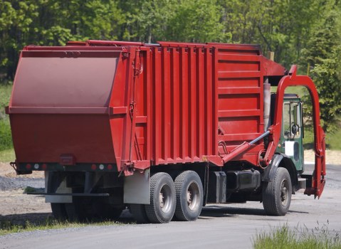 Workers segregating commercial waste into bins and containers